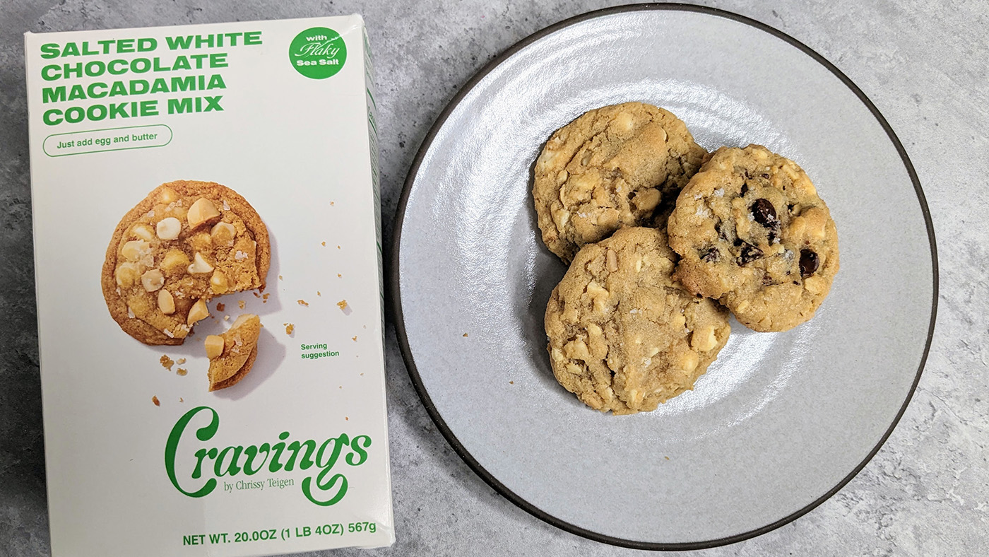 chrissy teigen cravings salted white chocolate macadamia cookies next to box