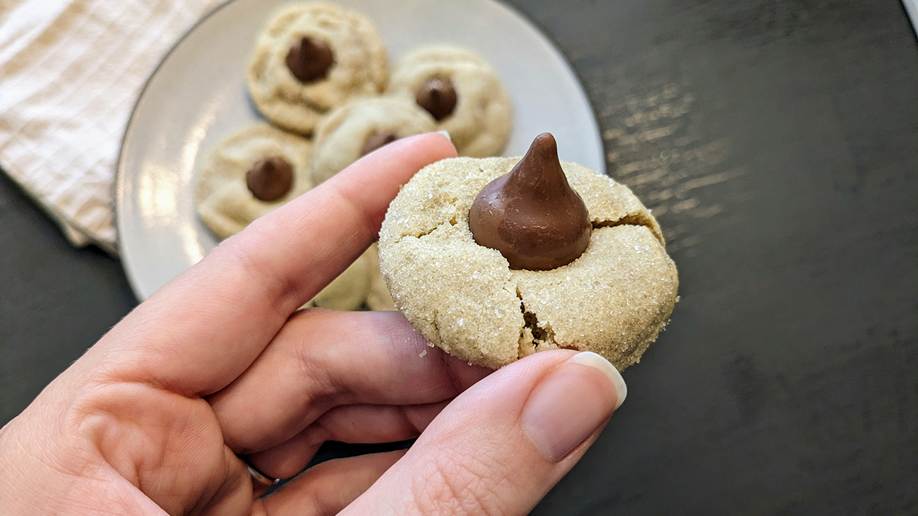 Close-up of a sugar cookie blossom, a sugar cookie topped with a Hershey's Kiss