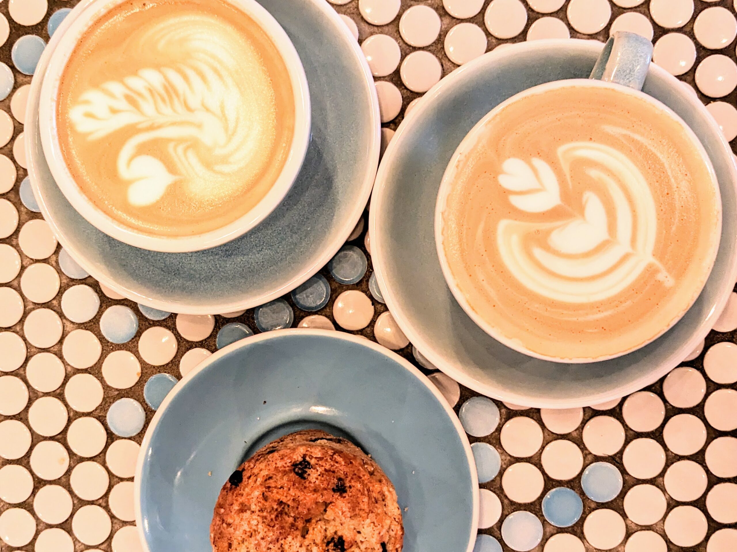 two lattes next to a muffin, to be sipped when trying a nap-a-latte