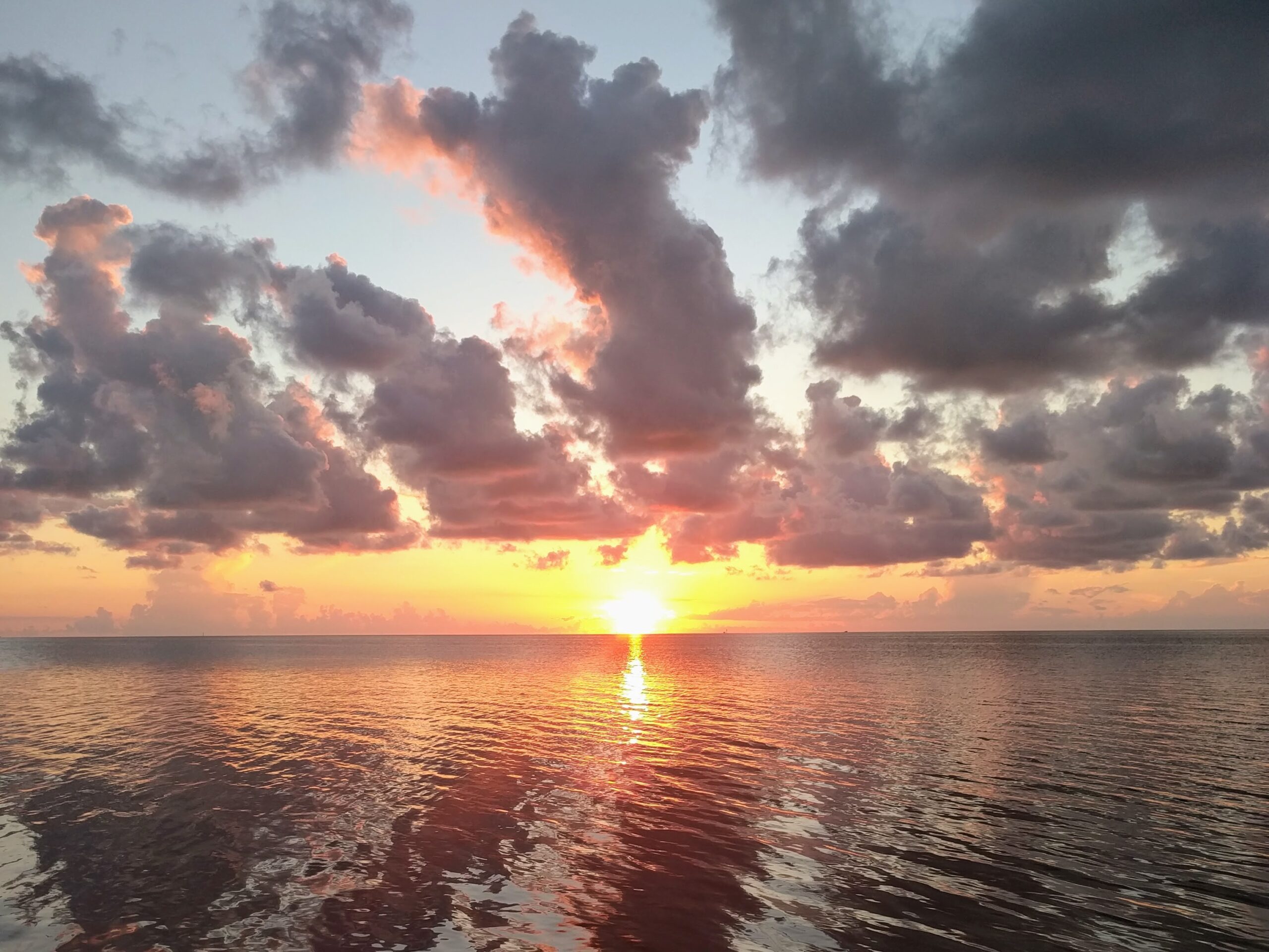 the sun rising over the water, signaling a fresh start