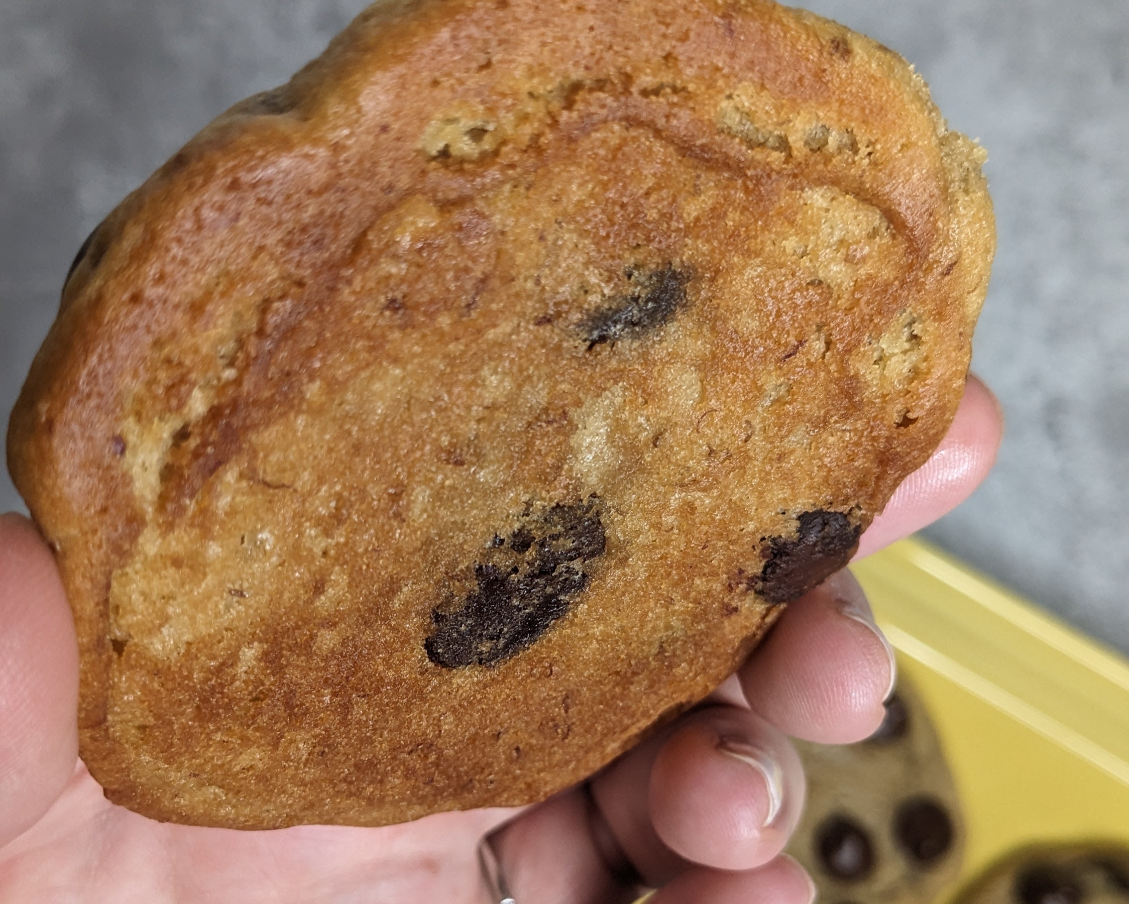 cookie with a tan bottom, showing how two sheet pans can prevent burning on bottom of cookies