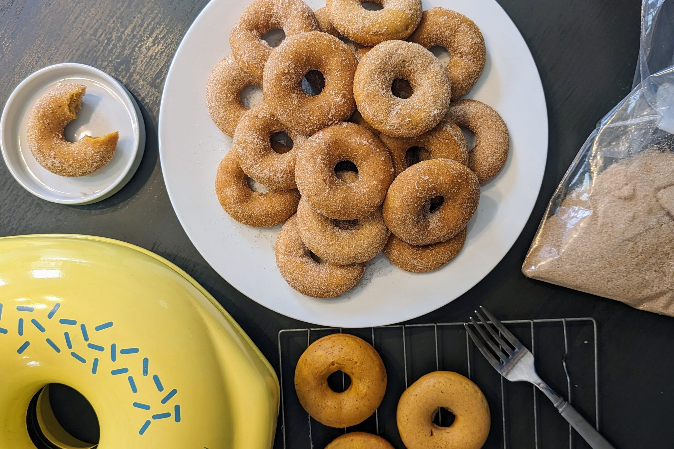 pumpkin donuts next to maker