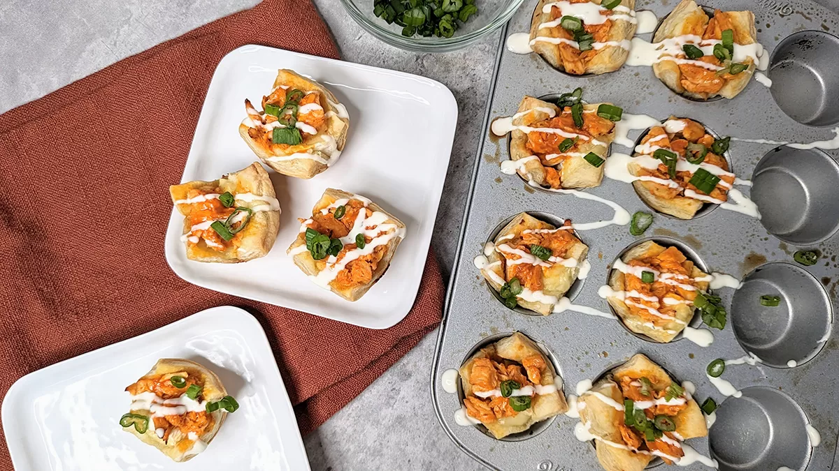 Buffalo chicken brie bites, cooked and drizzled with ranch