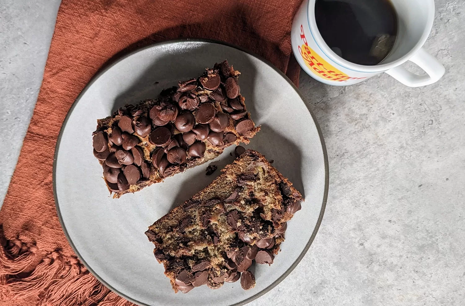 chocolate chip banana bread next to cup of coffee, inspired by gideon's bakehouse
