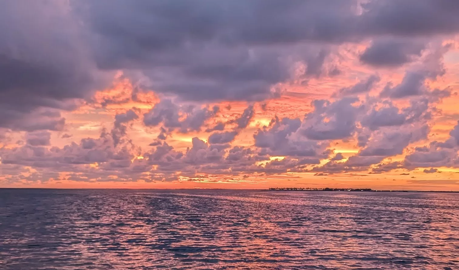 a pink and orange sunset over the water